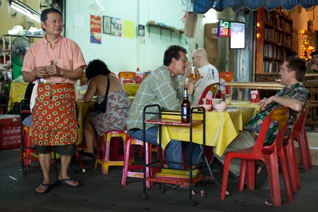 BANGKOK - JANUARY 12. Restaurant owner preying on potential customers near Khao San Road on January 12, 2012 in Bangkok, Thailand. It is common practice to entice new customers.のeditorial素材