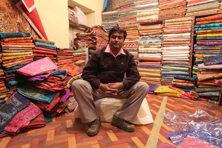 JAISALMER DECEMBER 2010 : Indian man posing in his textile shop in center of Jaisalmer, India on December 10. 2010. Price of cotton has increased due to floods.のeditorial素材