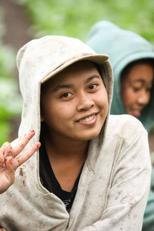 LAKE BATUR, BALI - JANUARY 21. Portrait of young woman on Lake Batur on January 21, 2012 in Bali, Indonesia. Children help their parents farming after school.のeditorial素材