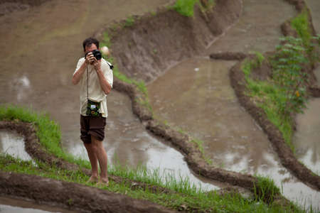 Photographer shooting locals in the paddy fields in Bali, Indonesia.のeditorial素材