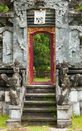 Entrance to indonesia hindu temple with carved wooden door.の写真素材
