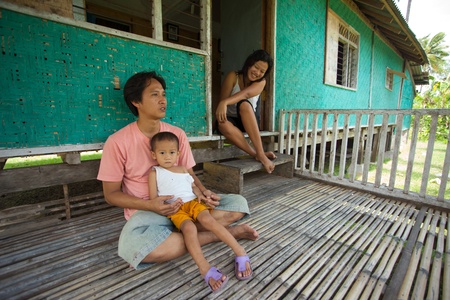 BALI - JANUARY 26. Muslim family at their home on January 26, 2012 in Bali, Indonesia. Muslims are a minority in Bali who arrive from muslim islands in Indonesia to make a better living.のeditorial素材