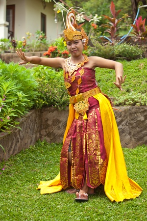 Young Balinese female dancer performing traditional Legong danceの写真素材
