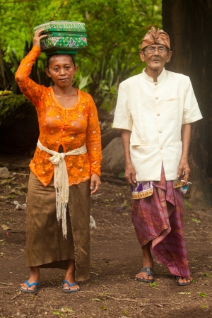 BALI - FEBRUARY 1. Local women carrying offerings to local temple for Galungan festivities on February 1, 2012 in Bali, Indonesia. Galungan's a Balinese holiday occuring every 210 days lasting 10 days.のeditorial素材