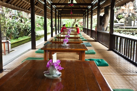 Cafe with low tables and green cushions with orchids on tablesのeditorial素材