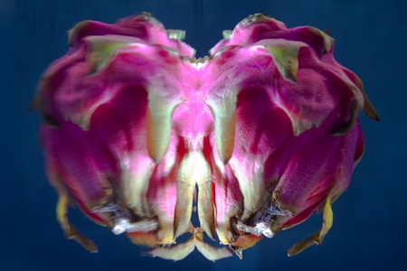 Abstract looking Dragon fruit underwater with surface reflectionの写真素材