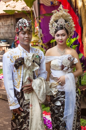 BALI - FEBRUARY 11. Couple enacting wedding scene in preparation for religious ceremony on February 11, 2012 in Bali, Indonesia. Most Balinese get married in their early 20s.の写真素材
