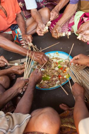 BALI - FEBRUARY 11. Villagers prepare food for wedding ceremony on February 11, 2012 in Bali, Indonesia. This fishing village community eat mostly pork.のeditorial素材