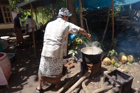 BALI - FEBRUARY 11. Villagers prepare food for wedding ceremony on February 11, 2012 in Bali, Indonesia. This fishing village community eat mostly pork.のeditorial素材
