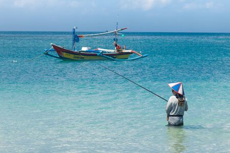 BALI - FEBRUARY 13. Line fishermen on Jimberan beach on February 13, 2012 in Bali, Indonesia. Local fishermen find it harder to make a living due to a lack of fish caused by industrial fishing.のeditorial素材