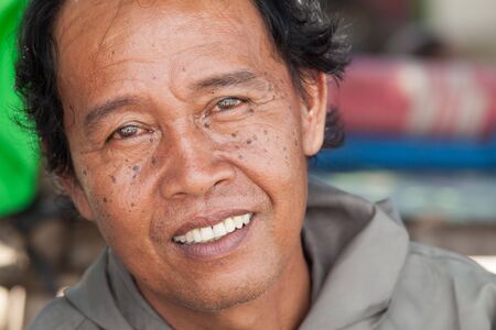 BALI - FEBRUARY 13. Portrait of line fisherman on Jimberan beach on February 13, 2012 in Bali, Indonesia. Local fishermen find it harder to make a living due to a lack of fish caused by industrial fishing.のeditorial素材