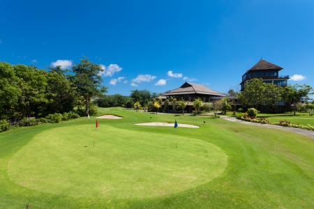 Green and holes in front of Golf clubhouse in Bali, Indonesia