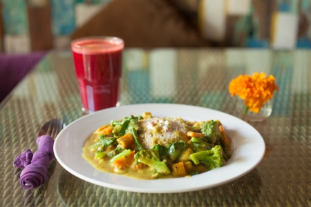 Beautiful vegetarian meal served with fresh juice and decorated with flowerの写真素材