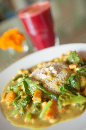 Beautiful vegetarian meal served with fresh juice and decorated with flowerの写真素材