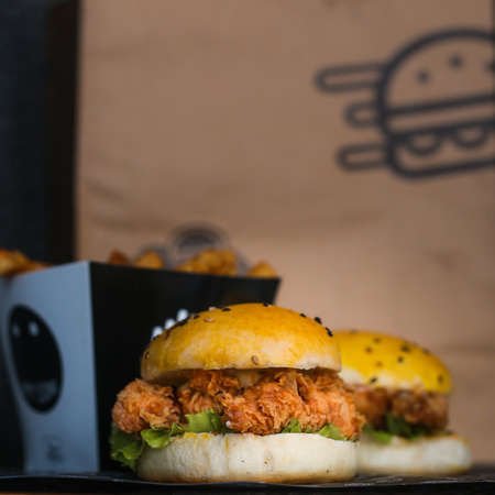 Chicken Zinger Burger with sesame beans topping and filled with vegetablesの写真素材