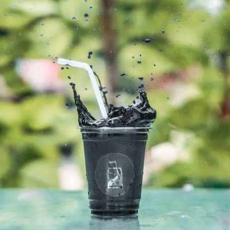 Smashed black chocolate in a glass and dropping outの写真素材