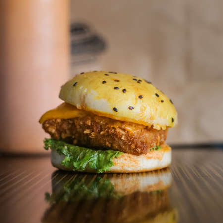 Chicken Zinger Burger with sesame beans topping and filled with vegetablesの写真素材
