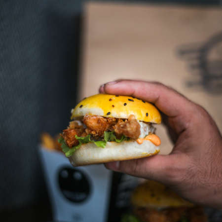 Chicken Zinger Burger with sesame beans topping and filled with vegetablesの写真素材