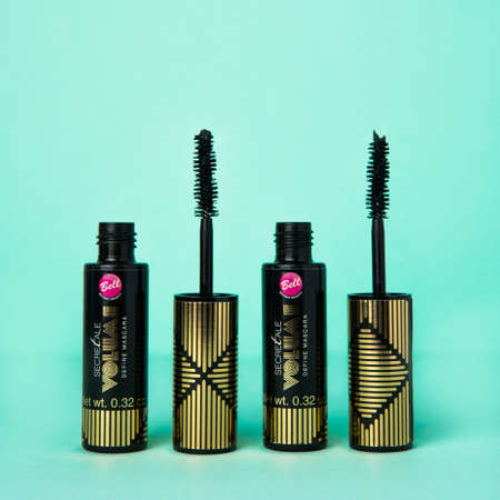 Mascara Bottle and Brush. Fashionable cosmetics Makeup for Eyes, Black Mascara wand and Tube Isolated on blue. Extensible mascara and volume, Mascara on Light Backgroundの写真素材