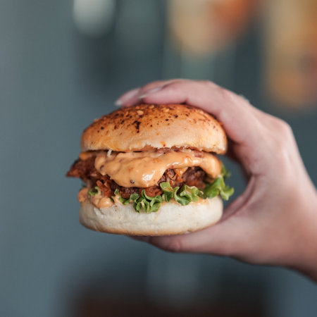 Chicken Zinger Burger with sesame beans topping and filled with vegetablesの写真素材