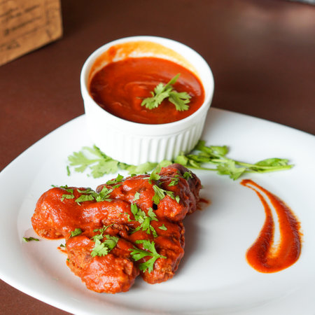 Chicken tikka masala served with tomato ketchup and parsleyの写真素材