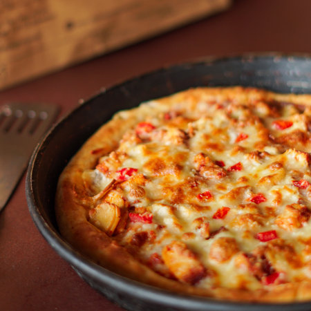 Pizza with chicken and mushrooms in a cast-iron frying panの写真素材