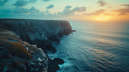 Sun Setting Over Ocean Near Cliffの素材