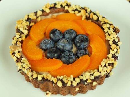 Chocolate tartlet with fruit and nutsの写真素材