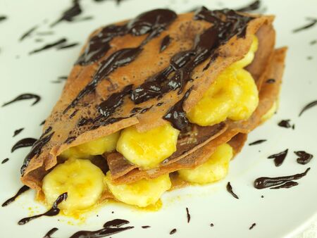 Wholemeal pancakes with bananas and chocolateの写真素材