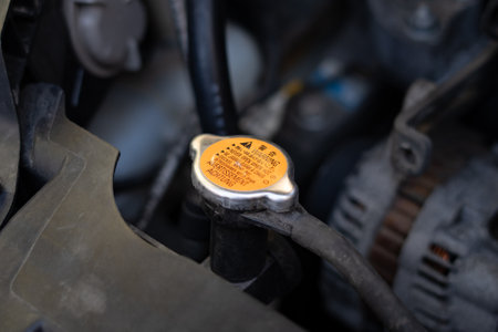 Antifreeze tank cap under the hood with multilingual Warning singの写真素材