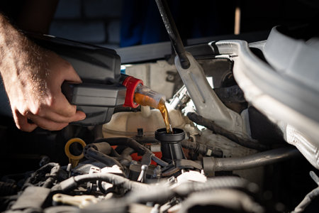 Engine oil is pouring into the engineの写真素材
