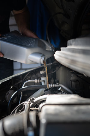 Engine oil is pouring into the engineの写真素材