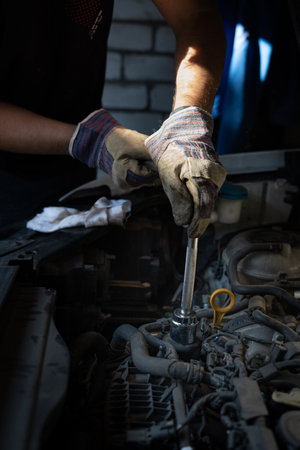 The mechanic repairs the car under the hoodの写真素材