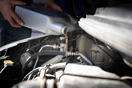 Engine oil is pouring into the engineの写真素材