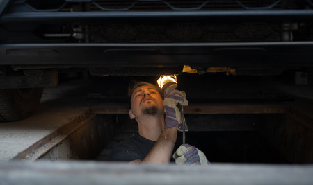 The mechanic services the car under the carの写真素材