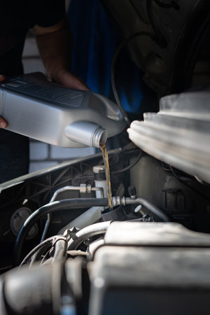 Engine oil is pouring into the engineの写真素材