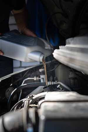 Engine oil is pouring into the engineの写真素材