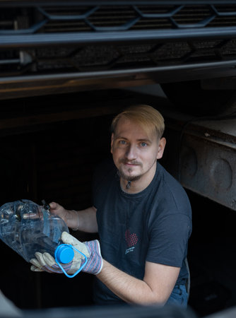 The mechanic services the car under the carの写真素材