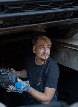 The mechanic services the car under the carの写真素材