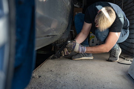 Mechanic replaces a wheel on a carの写真素材