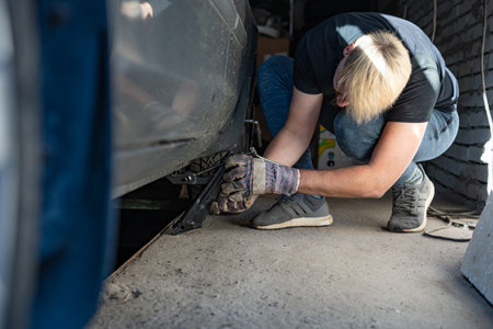 Mechanic replaces a wheel on a carの写真素材