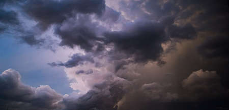 Diverse cumulus clouds and the sky before a thunderstormの写真素材