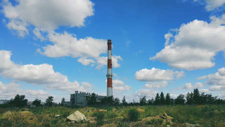 Boiler room chimney against the background of a sky and clouds