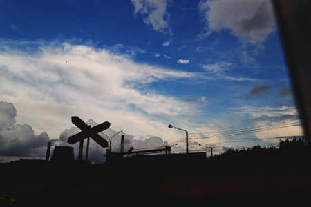 Silhouettes on a background of blue sky and white cloudsの写真素材
