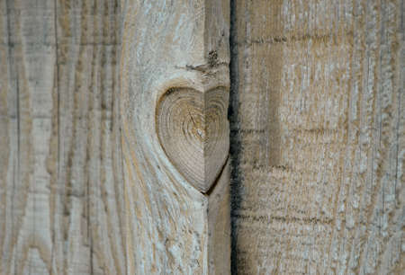 Heart symbol on wooden boards. Wood texture. Brown background. Macro. For a website, magazine and more.の写真素材