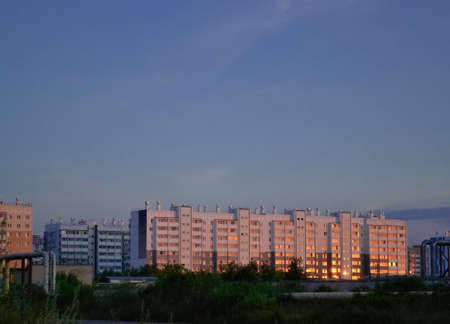Sunrise and sun reflection on residential buildings on the outskirts of the cityの写真素材