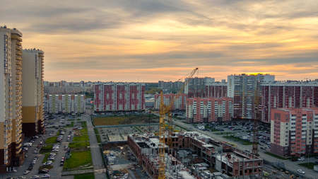 Top view of new buildings and residential buildings against the background of sunset and evening...