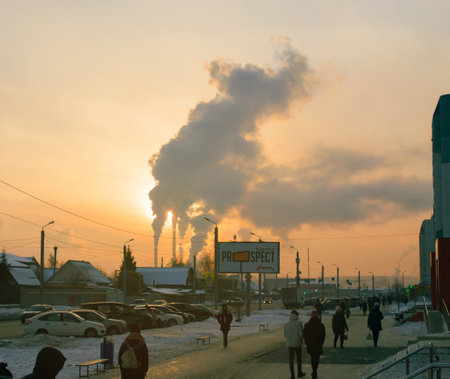 Chelyabinsk Russia - January 28, 2021. Salzman street. Winter life of a provincial town against the backdrop of sunset and smoke from the chimneys of a thermal power plantのeditorial素材