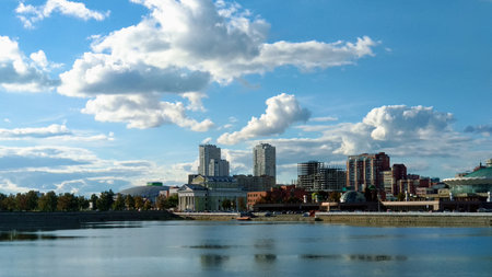 Buildings on the riverbank under a cloudy landscapeの写真素材