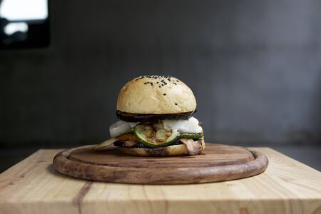 Tasty meat free burger on wooden table, Dark background.の写真素材
